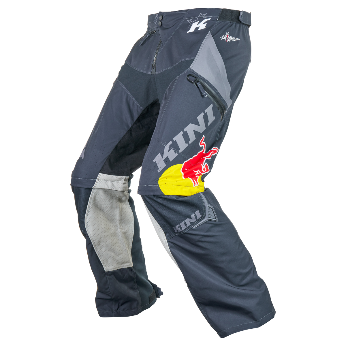 Die KINI RED BULL EXC X Hose 1.0 von Kini Red Bull ist eine schwarz-graue Motocross-Hose mit Mesh-Einsätzen, Reißverschlusstaschen und großen "KINI"- und Red Bull-Logos - perfekt als robuste Abenteuer- oder wasserdichte Outdoor-Hose. Auf weißem Hintergrund abgebildet.