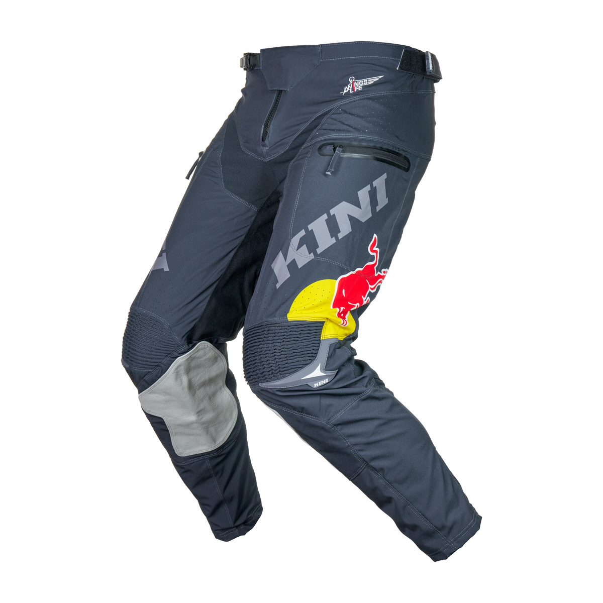 Die Kini Red Bull EXC Hose 1.0 in Schwarz und Grau verfügt über ein "KINI"-Branding, ein Red Bull-Logo, verstärkte Knie, Reißverschlüsse und verstellbare Hüftgurte - eine sportliche Hose von Kini Red Bull auf weißem Hintergrund.
